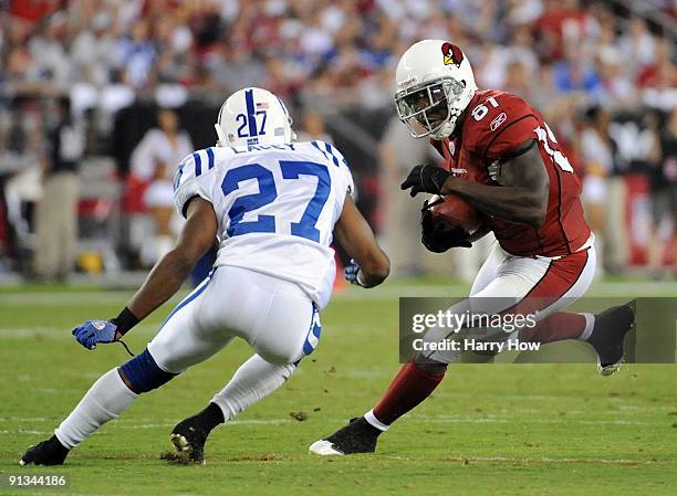 Anquan Boldin of the Arizona Cardinals runs after his catch as he is met by Jacob Lacey of the Indianapolis Colts during the game at University of...