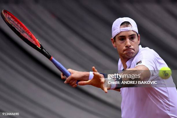 John Isner returns the ball to Serbia's Dusan Lajovic during the Davis Cup World Group first round single match between Serbia and USA at the Cair...