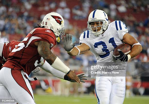 Donald Brown of the Indianapolis Colts runs toward Ali Highsmith of the Arizona Cardinals during the game at University of Phoenix Stadium on...
