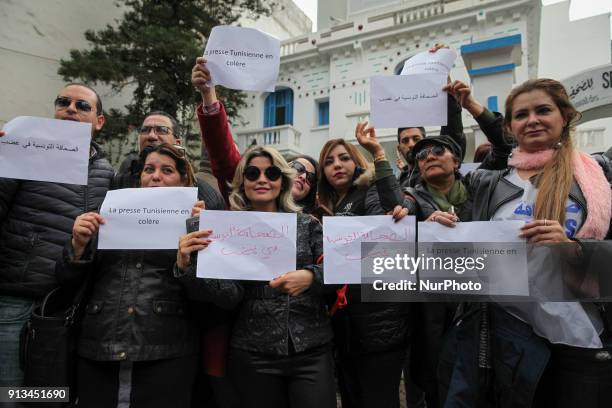Tunisian journalists hold placards that read 'Tunisian press in ange, during a demonstration held under the slogan Tunisian press in anger, outside...