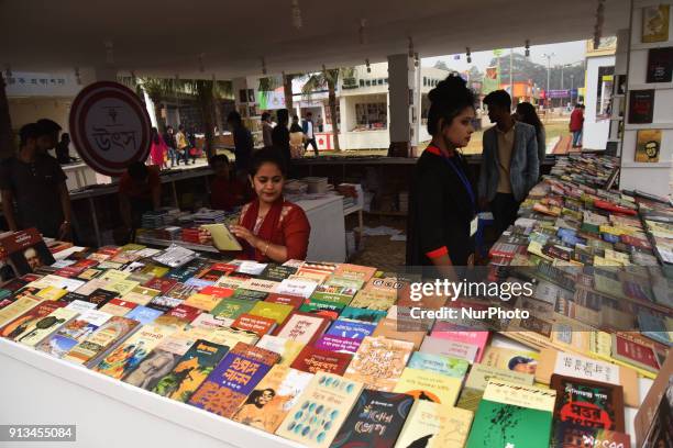 Bangladeshi shoppers brows books at a stall during the country's largest book fair in Dhaka on February 02, 2018. Bangladesh's largest book fair...