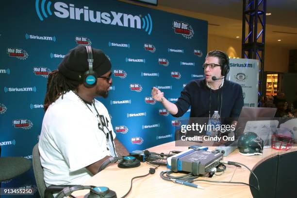 Damon "Snacks" Harrison and SiriusXM radio host Adam Schein attend SiriusXM at Super Bowl LII Radio Row at the Mall of America on February 2, 2018 in...