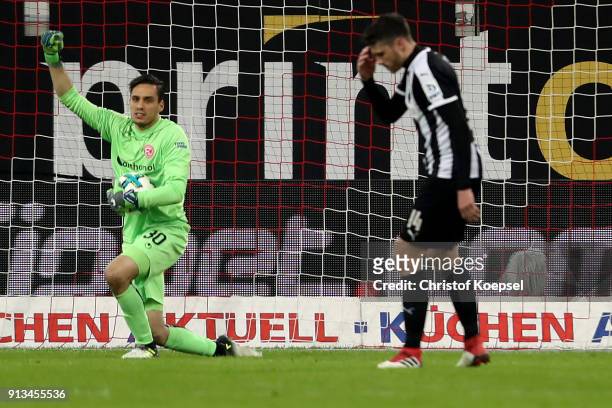 Raphael Wolf of Duesseldorf celebrates saving a penalty against Tim Kister of Sandhausen during the Second Bundesliga match between Fortuna...
