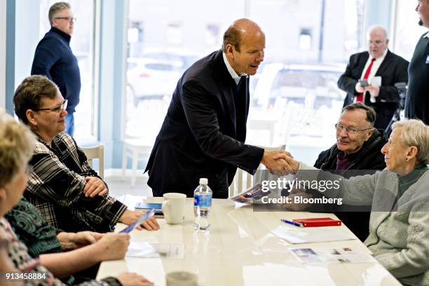 Representative John Delaney, a Democrat from Maryland and 2020 presidential candidate, shakes hands with an attendee during a campaign stop at...