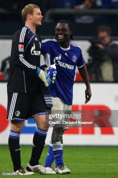 Manuel Neuer and Gerald Asamoah of Schalke celebrate the 2-0 victory after the Bundesliga match between FC Schalke 04 and Eintracht Frankfurt at...