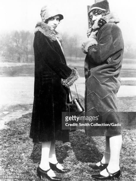 Photo, taken outdoorsin winter, left to right, of Roma Spencer and Frances Hill dressed in fur-trimmed coats, 1927. Image courtesy National Archives.