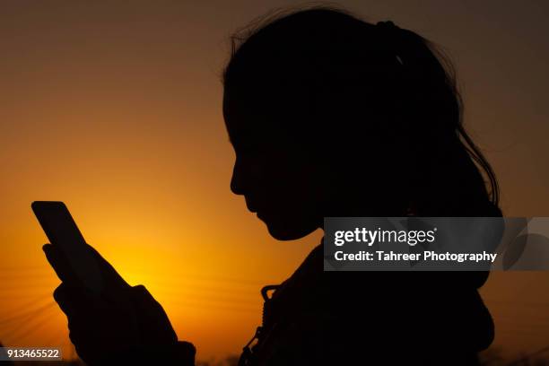 a girl using mobile - pakistan women stock pictures, royalty-free photos & images