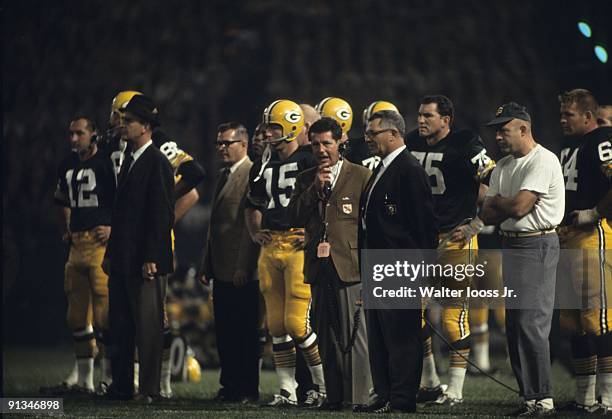Green Bay QB Bart Starr , coach Vince Lombardi, Forrest Gregg , and Jerry Kramer on sidelines during game vs Baltimore Colts at County Stadium....