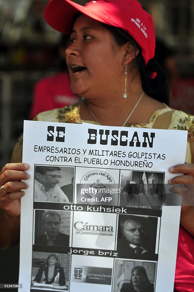 Unity Committee A member of the Peasant Unity Committee, displays a poster with... News ...