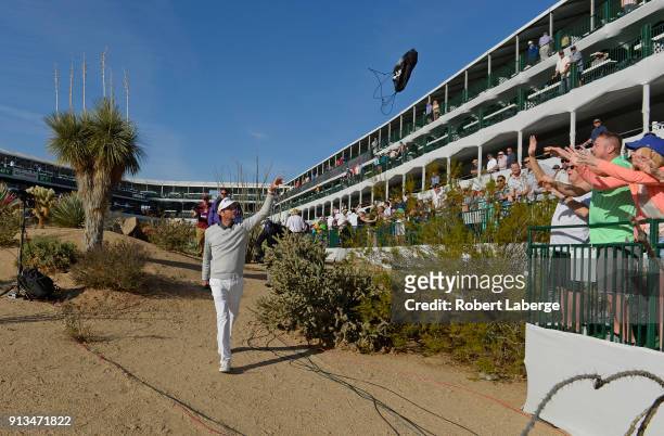 Bubba Watson throws bags to fans on the 16th hole during the second round of the Waste Management Phoenix Open at TPC Scottsdale on February 2, 2018...