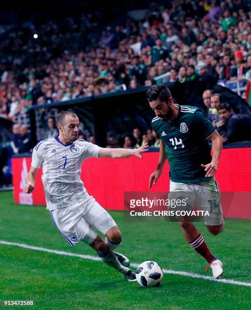 Bosnia & Herzegovina's Darko Todorovic vies for the ball with Mexico's Rodolfo Pizarro during a friendly football game at the Alamodome in San...