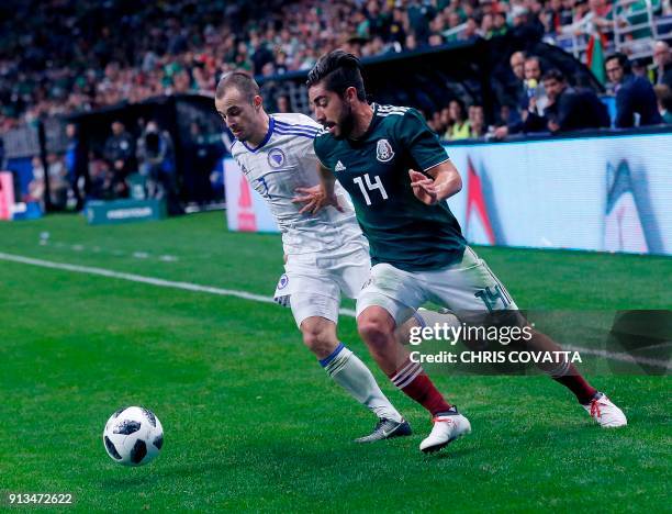 Bosnia & Herzegovina's Darko Todorovic vies for the ball with Mexico's Rodolfo Pizarro during a friendly football game at the Alamodome in San...