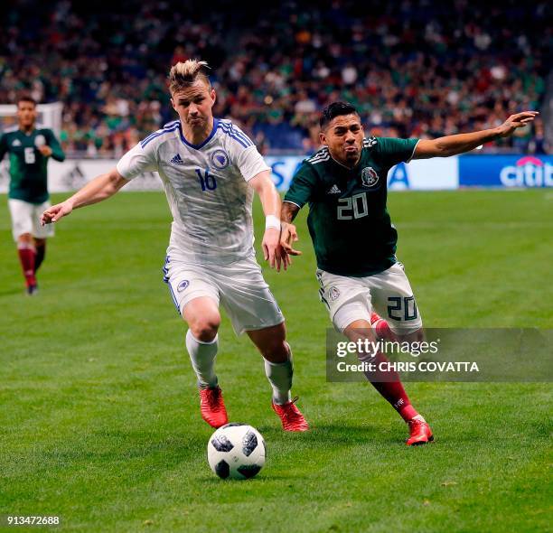 Bosnia & Herzegovina's Adnan Secerovic vies for the ball with Mexico's Javier Aquino during a friendly football game at the Alamodome in San Antonio,...