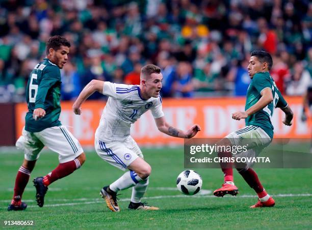 Bosnia & Herzegovina's Stjepan Loncar competes for the ball with Mexico's Javier Aquino and Mexico's Javier Aquino during a friendly football game at...