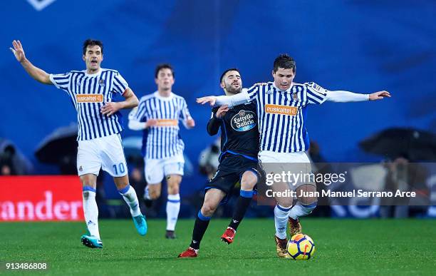 Carles Gil of RC Deportivo La Coruna duels for the ball with Igor Zubeldia of Real Sociedad during the La Liga match between Real Sociedad de Futbol...