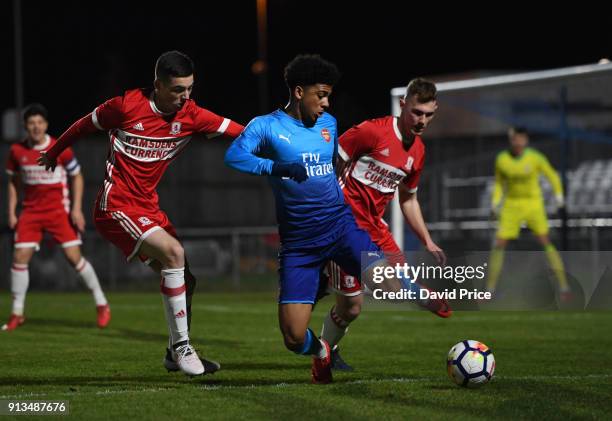 Xavier Amaechi of Arsenal turns away from Stephen Walker and Nathan Dale of Middlesbrough during the Youth Cup 5th round match between Middlesbrough...