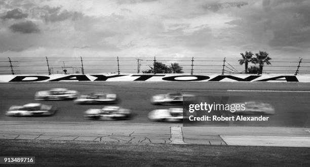 Racecars speed around the track in a blur during the 2003 Daytona 500 stock car race at Daytona International Speedway in Daytona Beach, Florida.