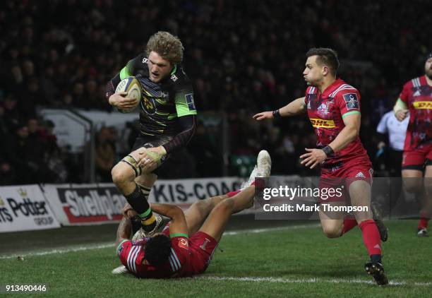 Jamie Gibson of Northampton is tackled by Alofa Alofa of Harlequins during the Anglo-Welsh Cup match between Northampton Saints and Harlequins at...