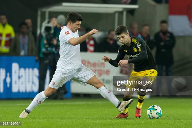 Milos Jojic of Koeln and Christian Pulisic of Dortmund battle for the ball during the Bundesliga match between 1. FC Koeln and Borussia Dortmund at...