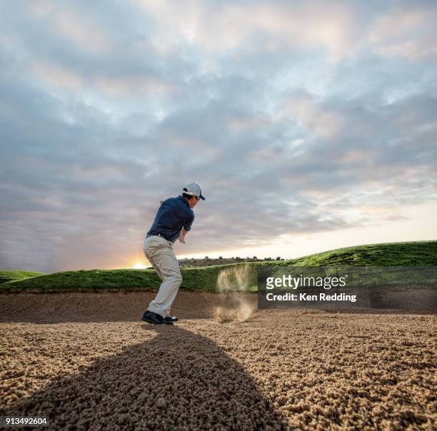 golfer pitching out of sand trap - bunker stockfoto's en -beelden