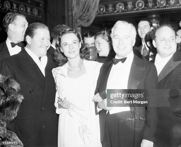 Jack Oakie, Paulette Goddard, and Charles Chaplin, stars of the Chaplin-directed film "The Great Dictator" at the film's opening held at the Capitol...