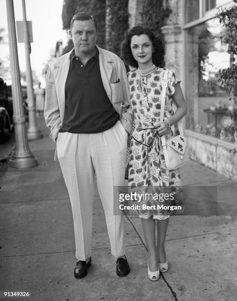 Mr and Mrs John Sims Kelly on sidewalk in Palm Beach, Florida, 1940s