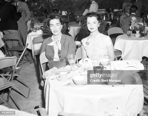 Mrs Alfred G Vanderbilt and Mrs John Sims Kelly sitting at table, Hileah Race Track, Florida, c1945