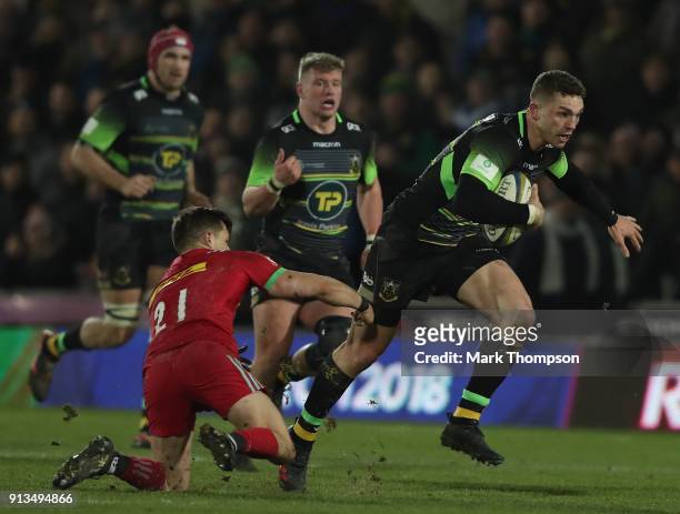 George North of Northampton Saints is tackled by Jono Kitto of Harlequins during the Anglo-Welsh Cup match between Northampton Saints and Harlequins...