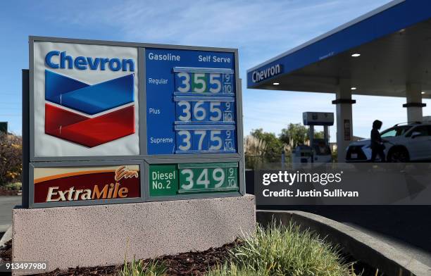 Sign is posted in front of a Chevron gas station on February 2, 2018 in Corte Madera, California. Chevron reported fourth quarter earnings that...