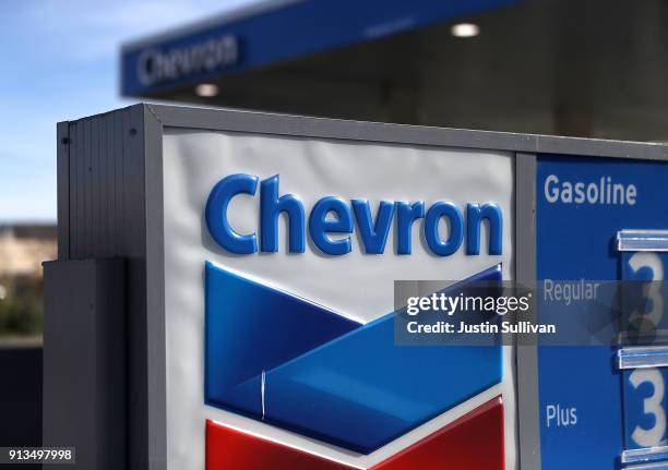 Sign is posted in front of a Chevron gas station on February 2, 2018 in Corte Madera, California. Chevron reported fourth quarter earnings that...