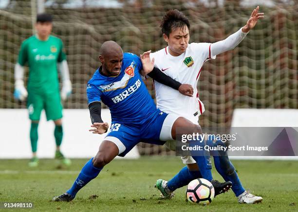 Lin Longchang Guizhou Henfeng Zicheng competes for the ball with Luiz Muriqui of Meizhou Meixian during the friendly match between Guizhou Henfeng...