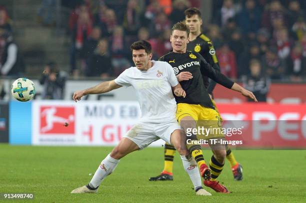 Milos Jojic of Koeln and Lukasz Piszczek of Dortmund battle for the ball during the Bundesliga match between 1. FC Koeln and Borussia Dortmund at...