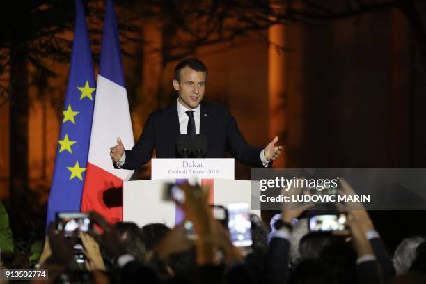 French President Emmanuel Macron meets delivers a speech in the garden of the French Embassy in Dakar on February 2 as part of the French president's...