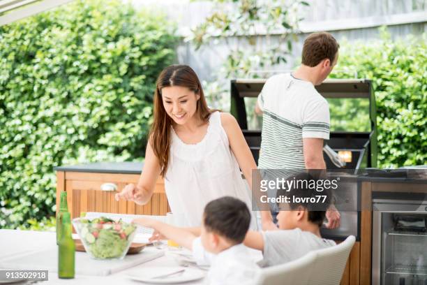family preparing lunch - outdoor kitchen stock pictures, royalty-free photos & images