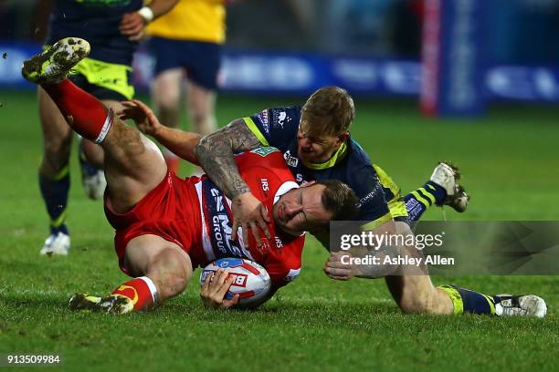 Hull KR's Adam Quinlan is tackled by Tom Johnstone of Wakefield Trinity during the BetFred Super League match between Hull KR and Wakefield Trinity...