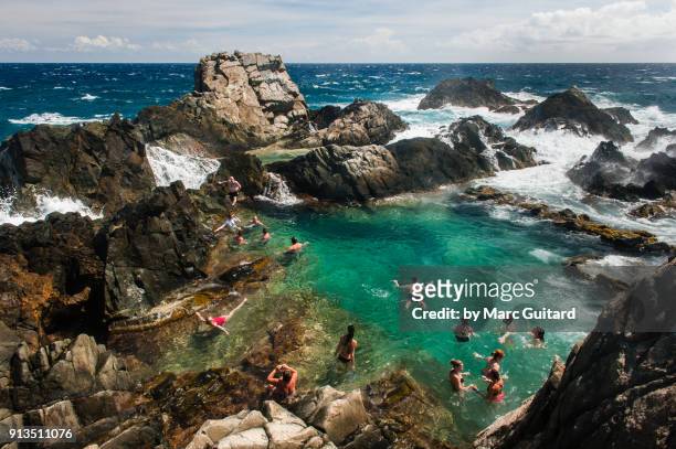 natural pool in arikok national park on the north coast of aruba - aruba beach stock-fotos und bilder