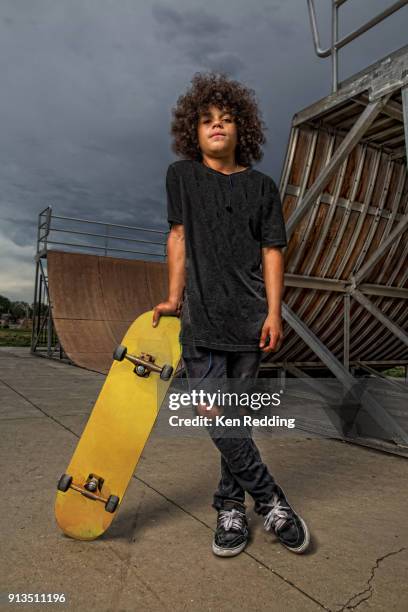 teenage boy posing with skateboard - boy skatepark stock-fotos und bilder