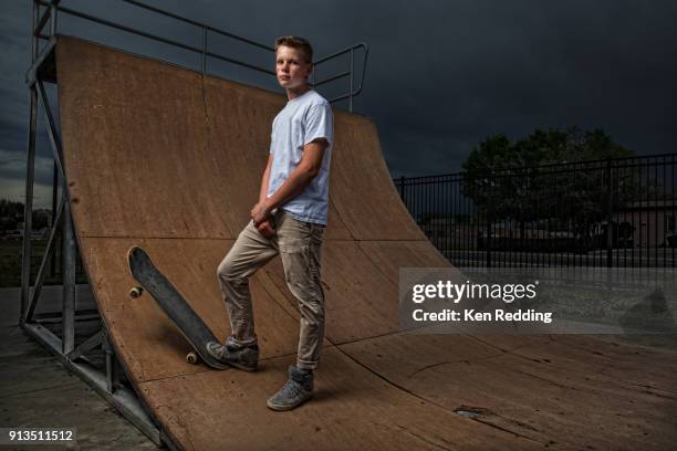 teenage boy posing with skateboard on half pipe - skateboarding half pipe stock pictures, royalty-free photos & images