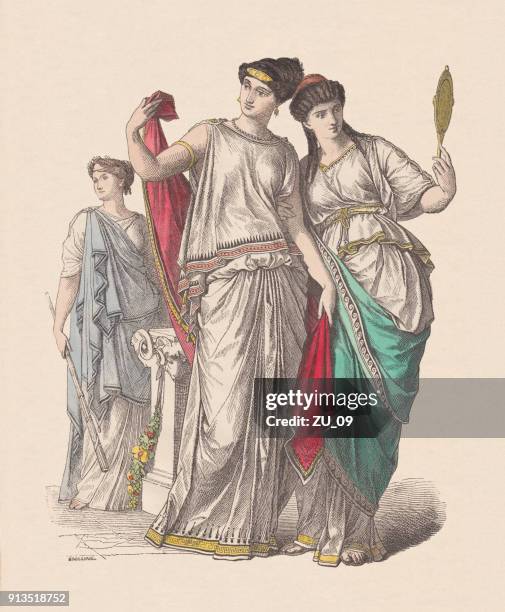 ancient greek fashion: priestess (left), and noble ladies, published c.1880 - greece costume stock illustrations