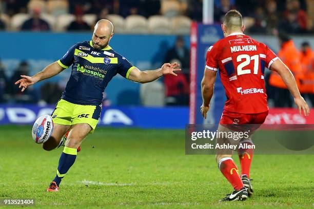 Wakefield Trinity's Liam Finn kicks the all down the ground as Hull KR's Robbie Mulhern looks on during the BetFred Super League match between Hull...