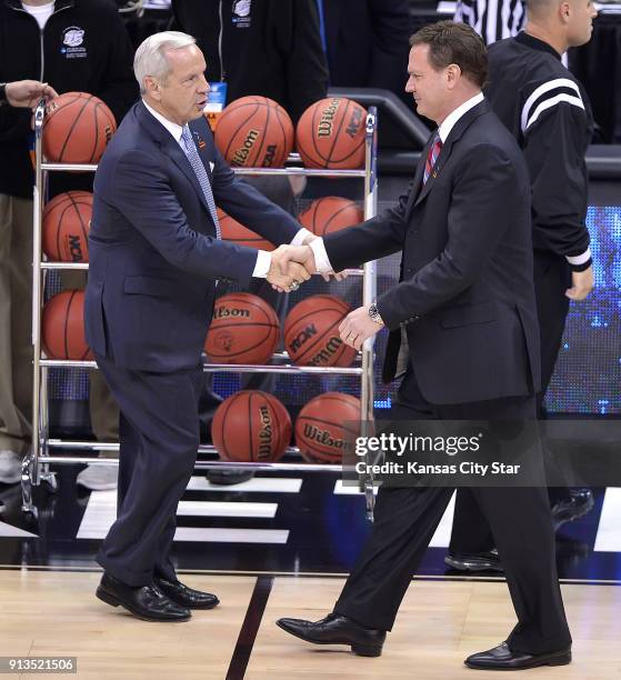 North Carolina Tar Heels head coach Roy Williams, left, greets Kansas Jayhawks head coach Bill Self prior to a third-round game in NCAA Tournament at...