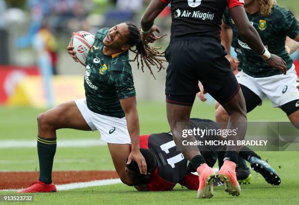 South Africa's Justin Geduld reacts as he is tackled during the World Rugby Sevens Series match between Papua New Guinea and South Africa at Waikato...