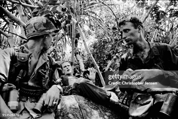 View of a trio of unidentified US Army soldiers as they take a break during a jungle patrol, II Corps , Republic of Vietnam, June 1, 1970.