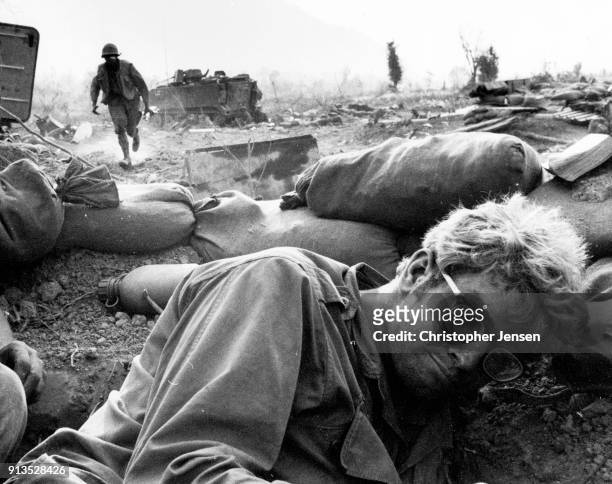 An unidentified US Army soldier lies in a crater as another sprints for cover during a mortar attack along Route Nine, I Corps , Republic of Vietnam,...