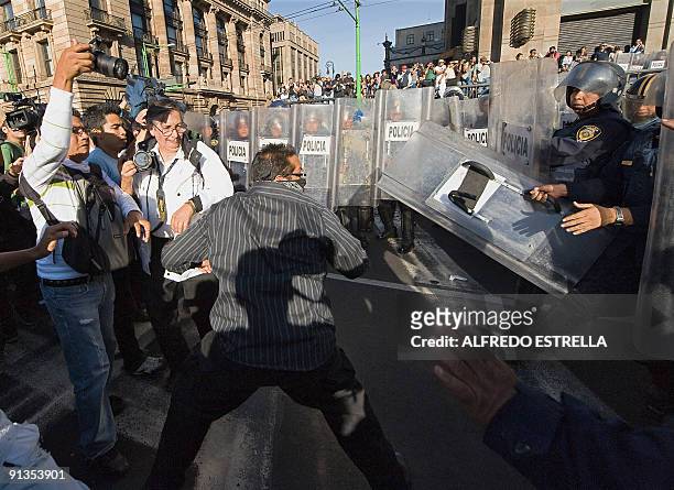 Students confront the police during the anniversary of the massacre of Tlatelolco, at the Plaza de las Tres Culturas, in Mexico City, on October 2,...
