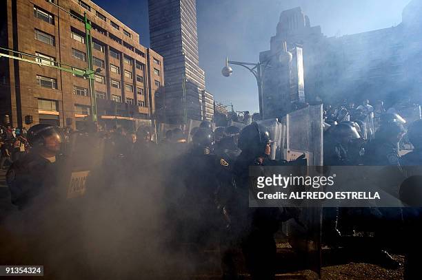 Police officers clash with students during the anniversary of the massacre of Tlatelolco, at the Plaza de las Tres Culturas, in Mexico City, on...
