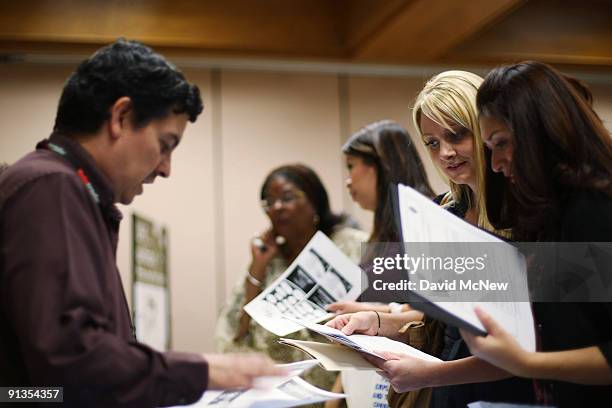 Raul Mendez , a job recruiter with the County of Los Angeles Probation Department, talks to job seekers Kate Herrier and Maritza Arevalo at the...