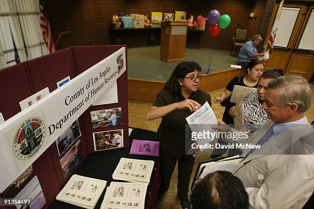 Ann Gomez of the County of Los Angeles Department of Human Resources, talks to job seekers at the Senior Job Fair at the Arcadia Community Center on...