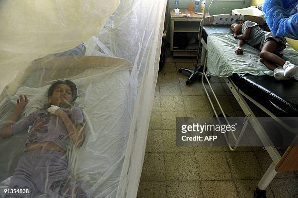 Alejandra Betanco and Miguel Sanchez are seen in the children's ward for patients with dengue fever in the La Mascota hospital in Managua on October...