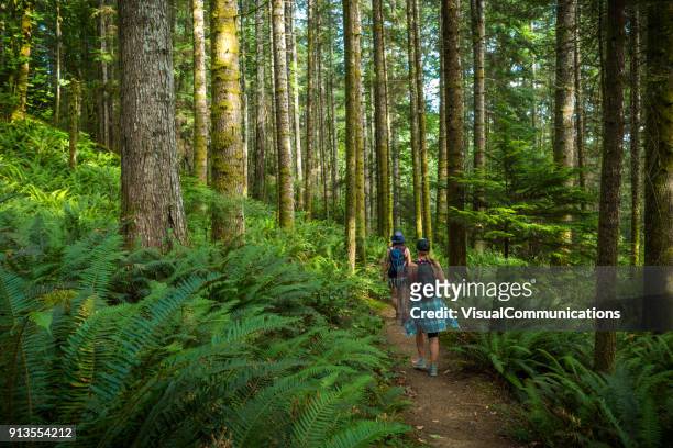 two women hiking ripple rock trail on vancouver island. - vancouver island stock pictures, royalty-free photos & images